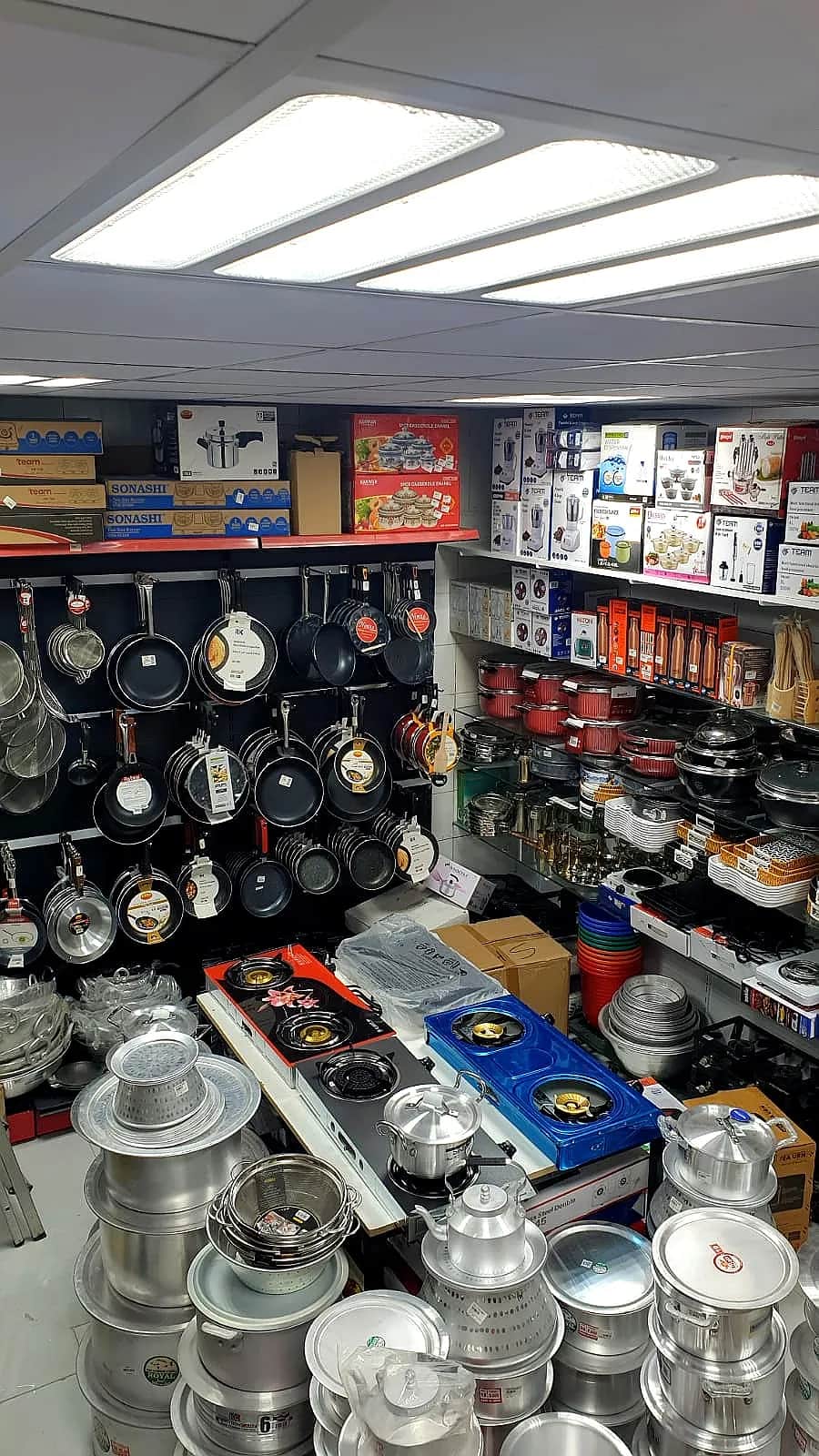 Cookware and equipment displayed on Shop House shelves